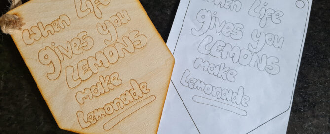Paper drawing with personalised artwork drawn onto it and wooden sign with the personalised artwork laser engraved onto it.