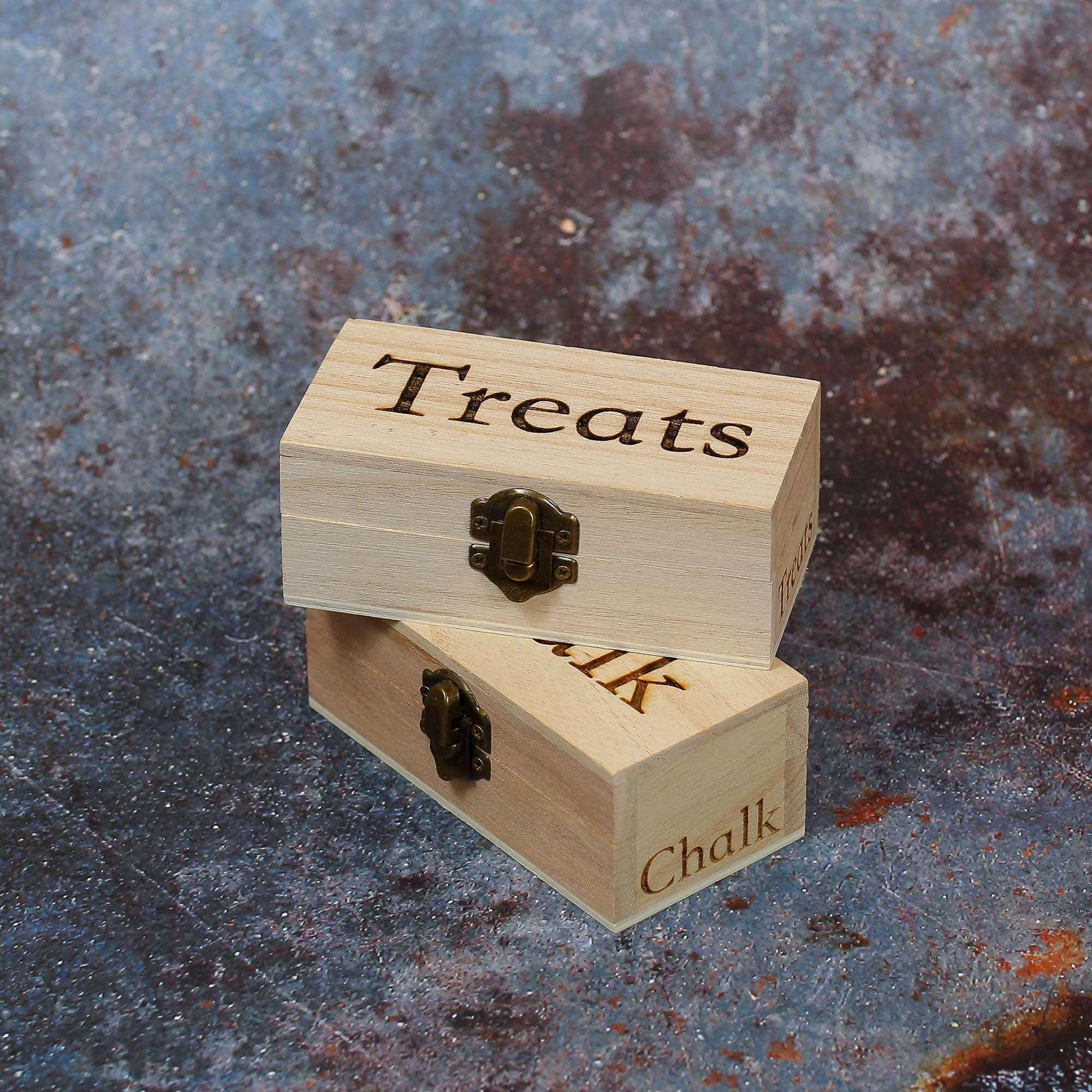 Two small stacked boxes laser engraved with treats on.