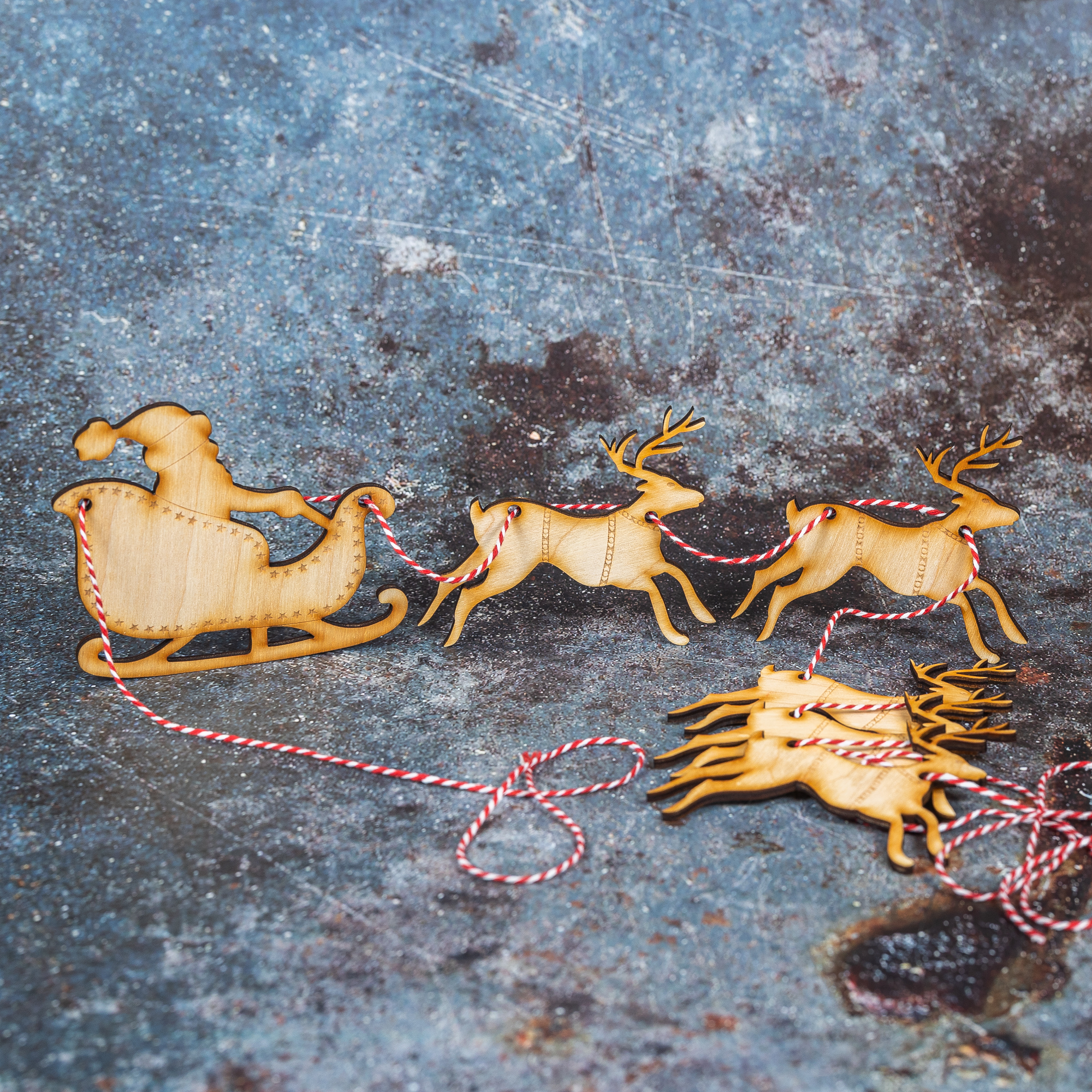 Wooden Santa sleigh bunting with 5 reindeer on a red and white twine.