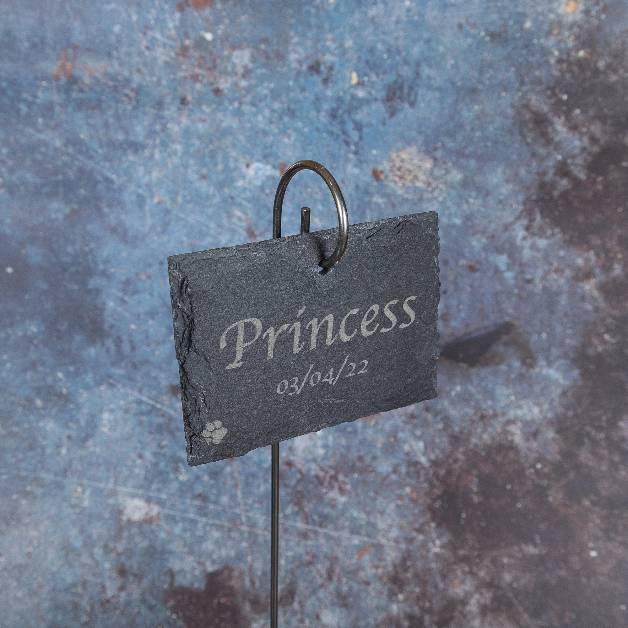 Slate sign with Princess, a date and a pawprint engraved on it.