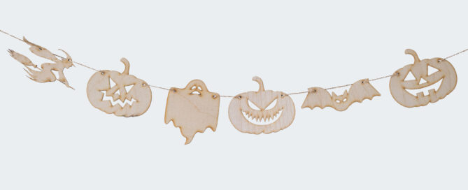 Wooden bunting shaped as pumpkins, a ghost, a witch and a bat.