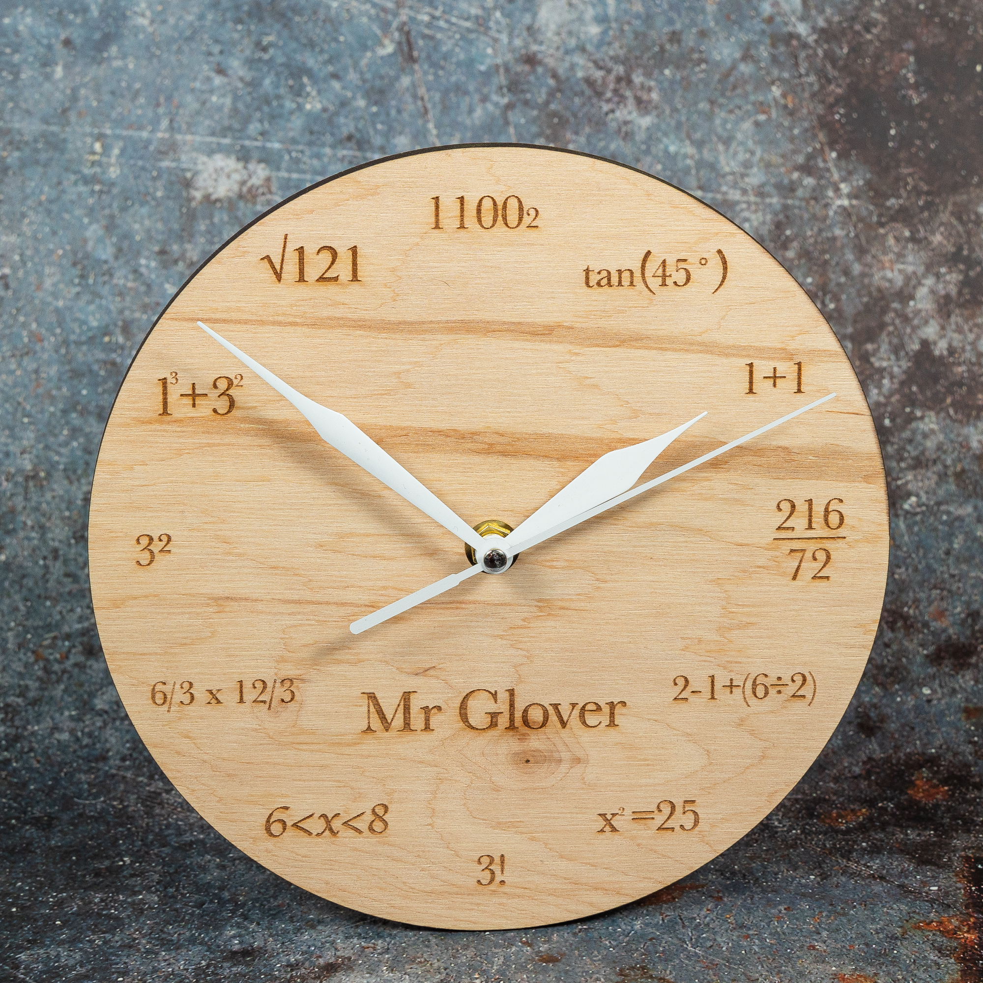 Wooden clock with maths equations instead of numbers.