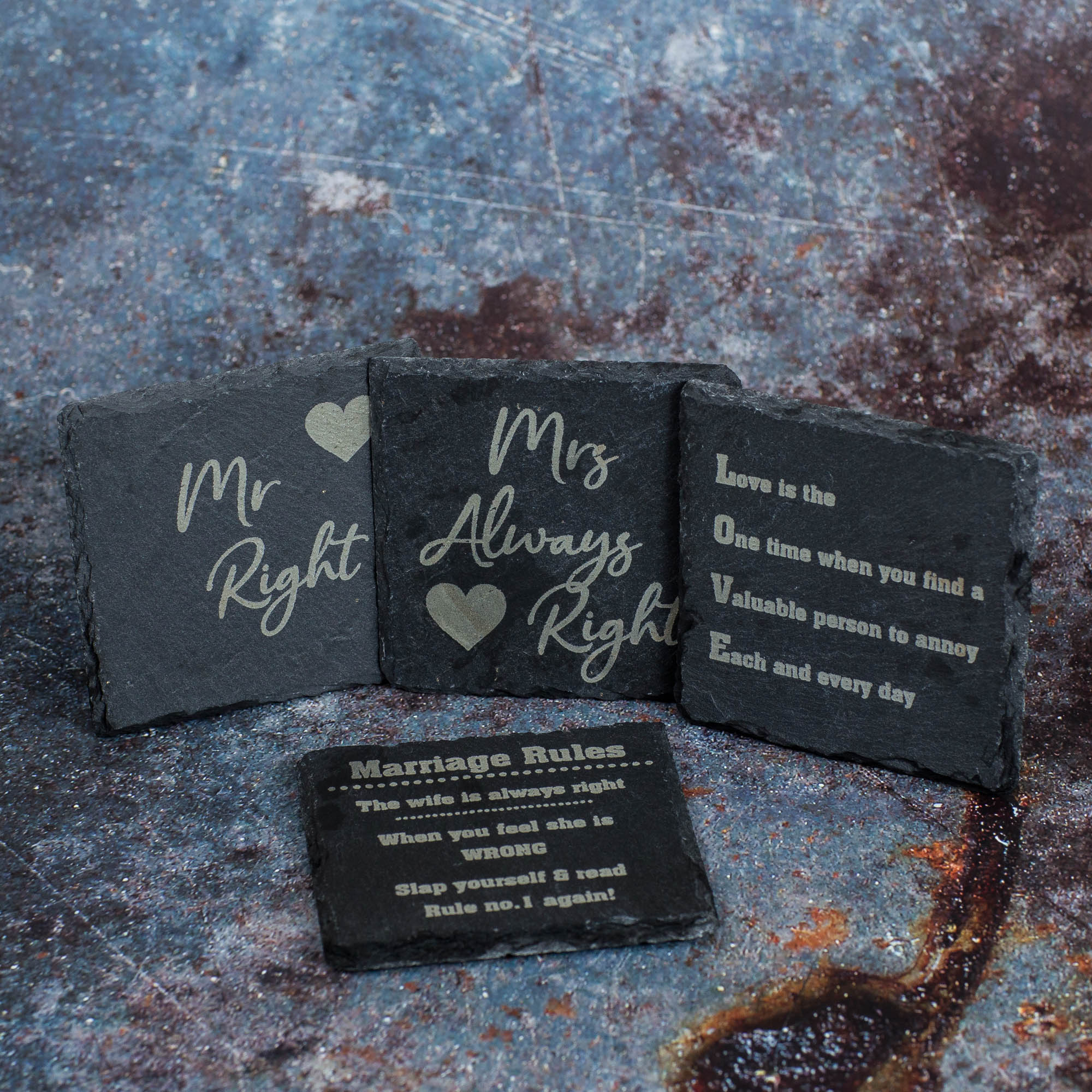 Four slate coasters engraved with wedding quotes.