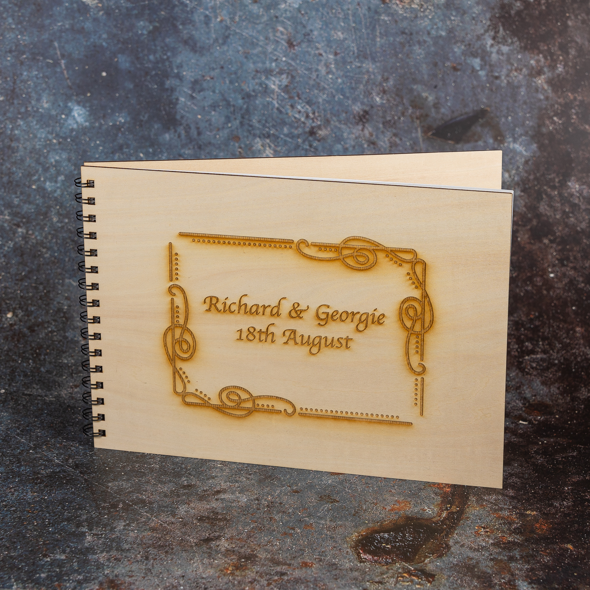 Wooden guest book engraved with couple's name and date.