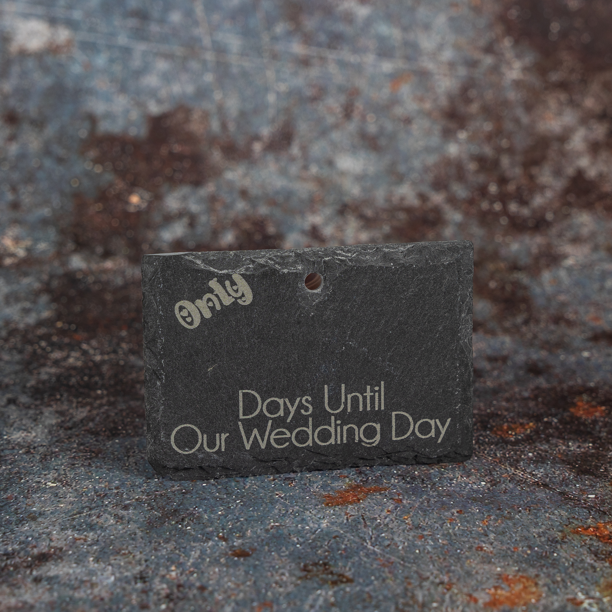 Slate sign with only (blank) days until our wedding day engraved on it.
