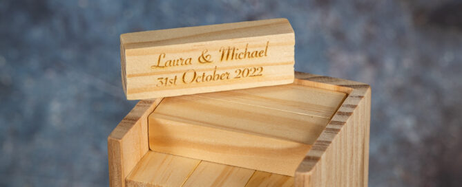 Close up of tumble tower blocks engraved with wedding couple's details.
