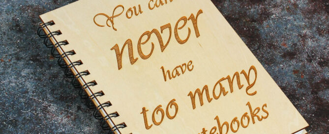 PLy bound note book with spiral bind and the text You can never have too many notebooks engraved on it.