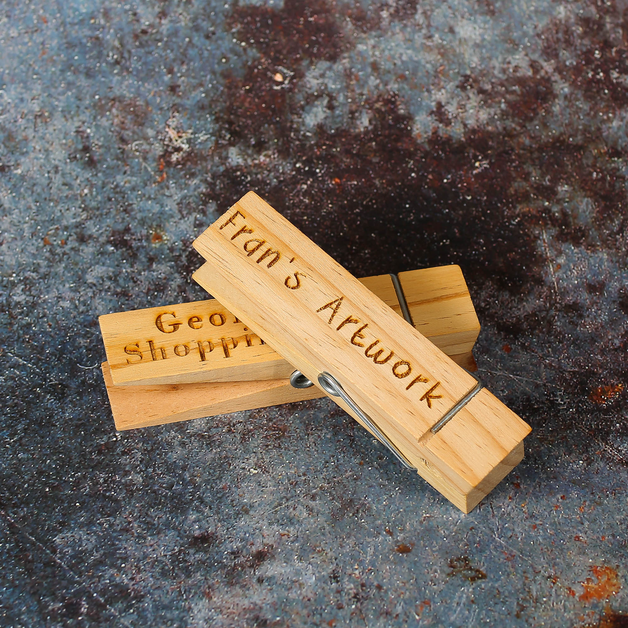 Giant wooden pegs with personalised text engraved on them.