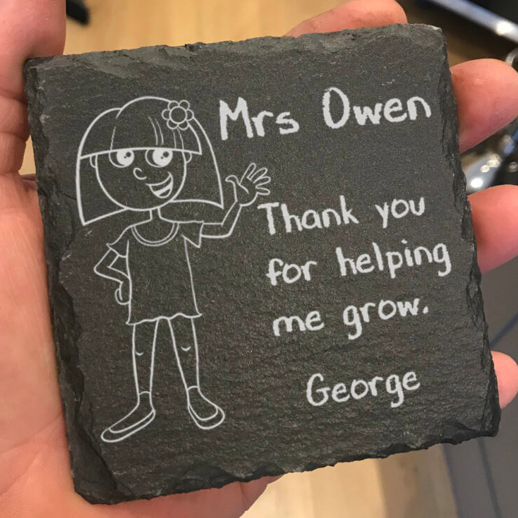 Slate coaster with a cartoon image of a young girl and the words Mrs Owen, Thank you for helping me grow, Georgie engraved on it.