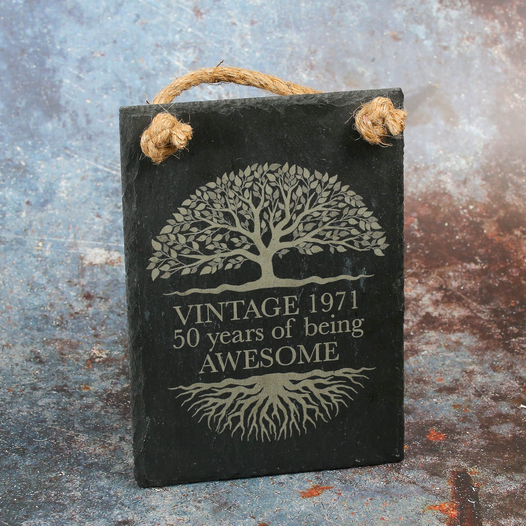 Roped slate sign with an oak tree of life on it and text that says vintage 1971, 50 years of awesome.