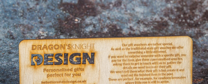 Wooden rectangle engraved with text regarding how the business's gift vouchers work.