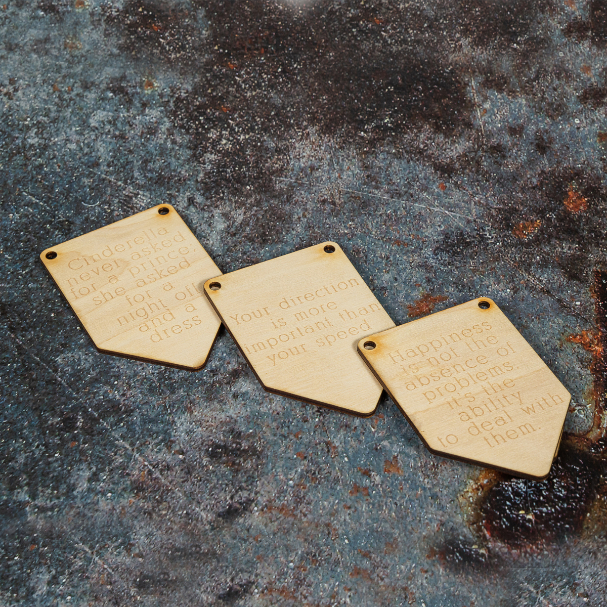 Three wooden bunting flags laser engraved with affirmation quotes.