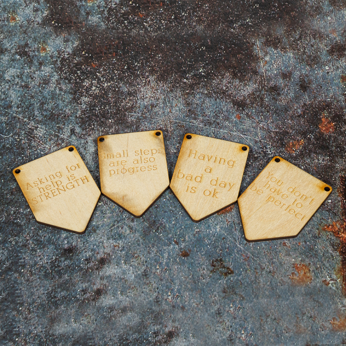 Four wooden bunting flags laser engraved with affirmation quotes.