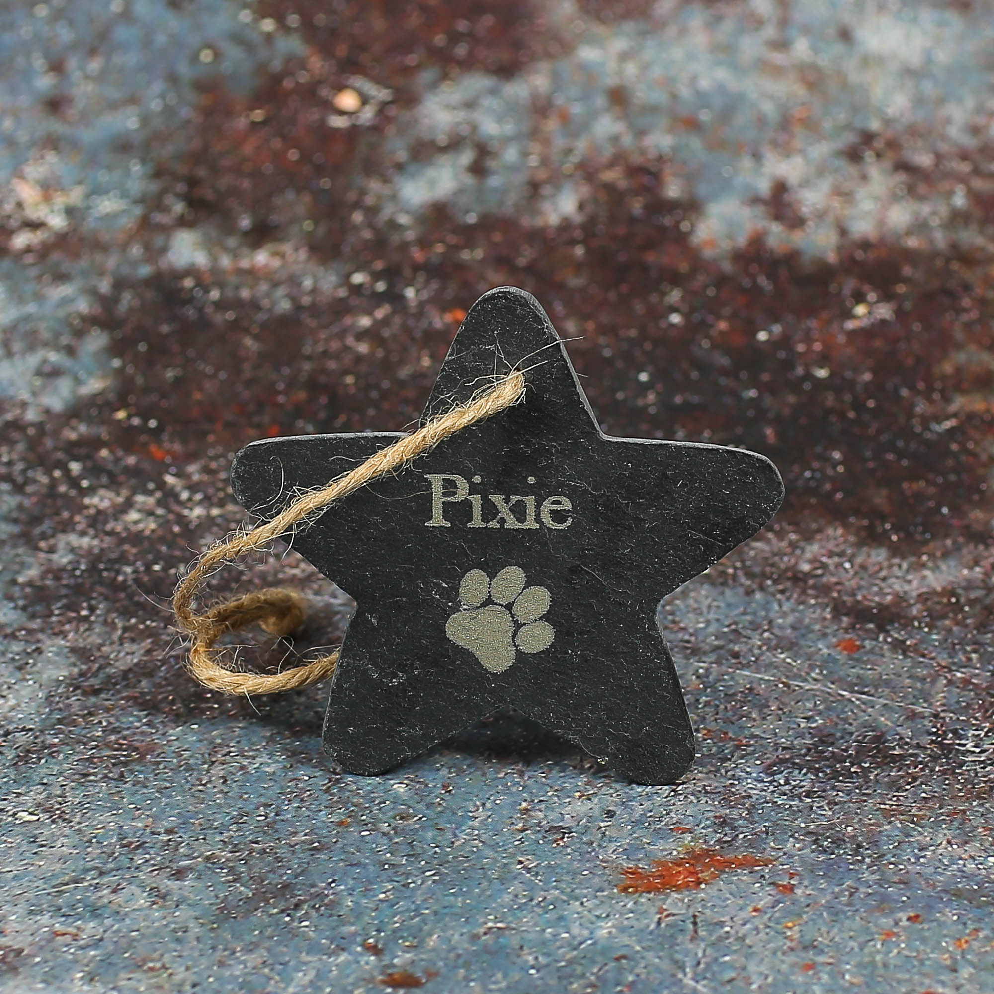 Slate star drilled with twine for hanging and the name Pixie laser engraved on with a pawprint.