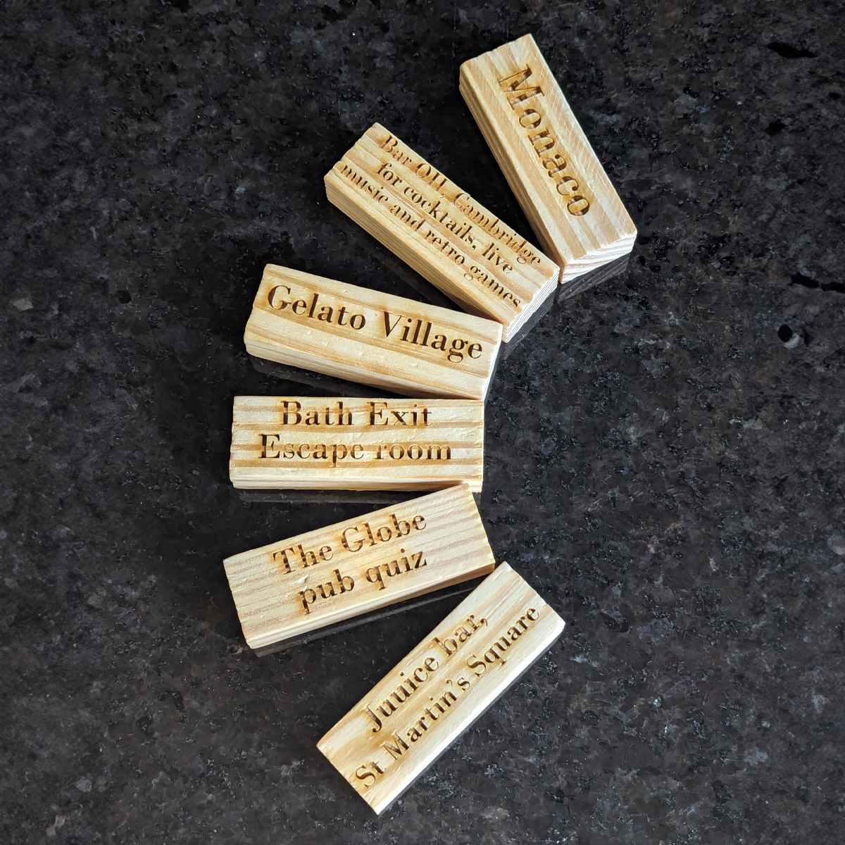 Set of tumble tower blocks fanned out in a crescent. Each is laser engraved with various different days out.