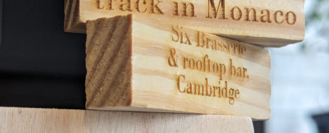 Two tumble tower blocks perched on top of each other. Both are laser engraved with text from days out.